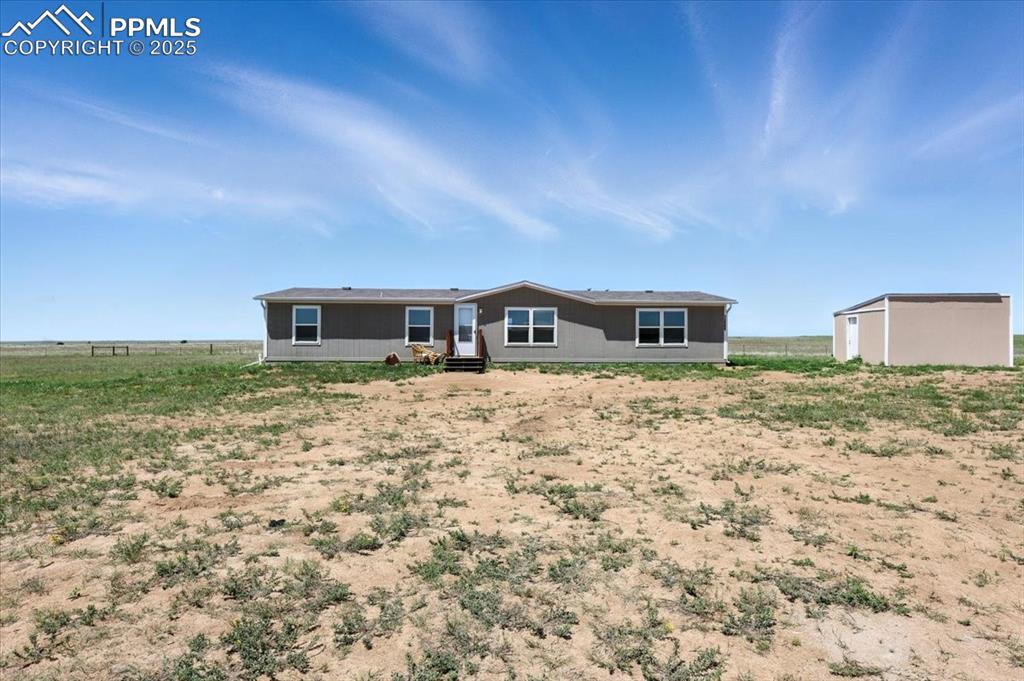 13560 Whittemore Road Yoder, CO 80864 - Photo 30 of 50 a front view of a house with a yard