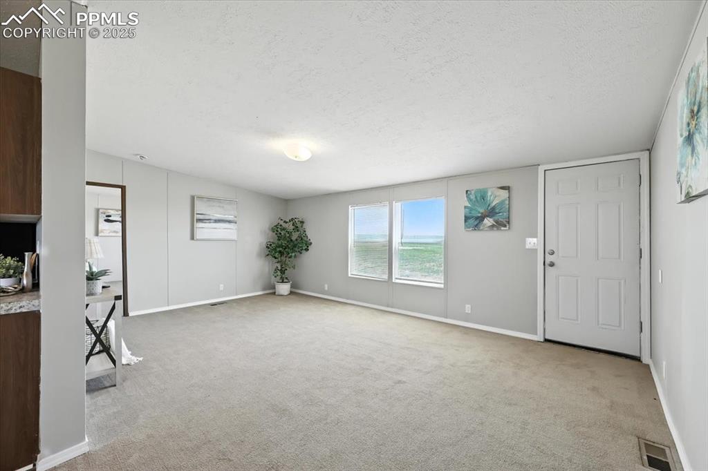 13560 Whittemore Road Yoder, CO 80864 - Photo 3 of 50 a view of an empty room with a window