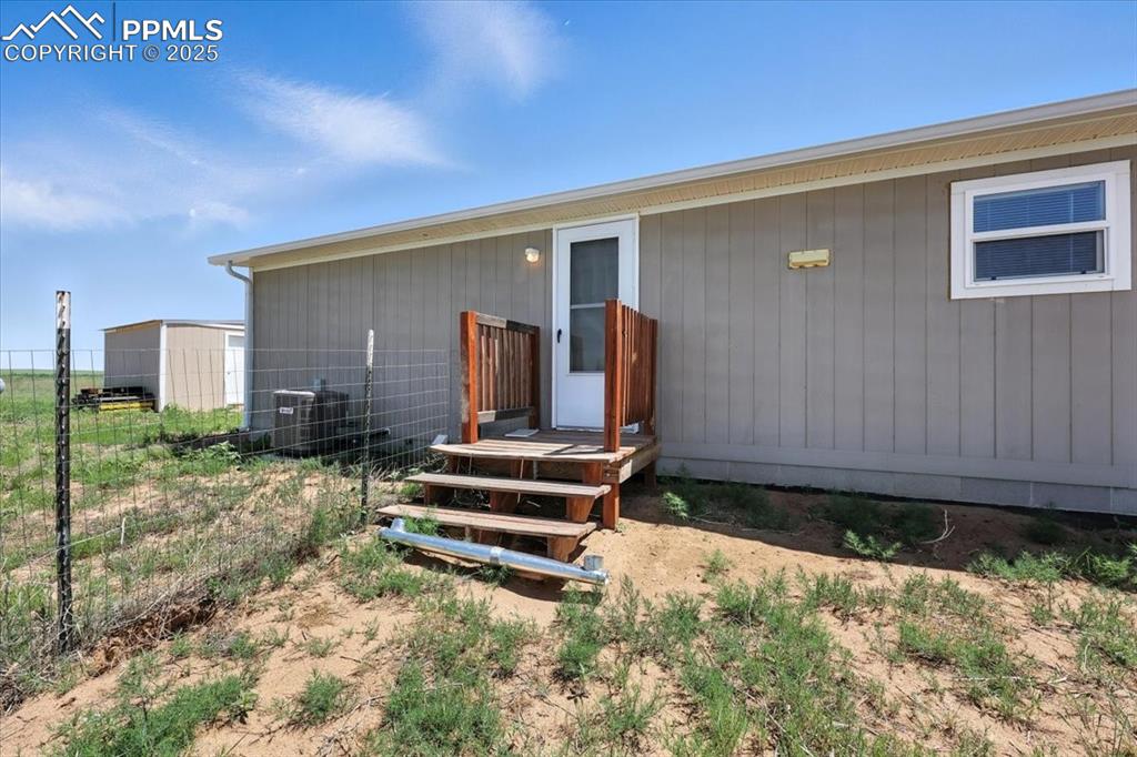 13560 Whittemore Road Yoder, CO 80864 - Photo 33 of 50 a backyard of a house with barbeque oven
