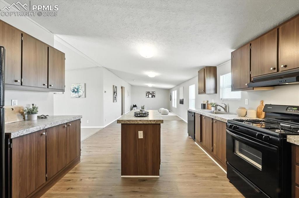 13560 Whittemore Road Yoder, CO 80864 - Photo 9 of 50 a kitchen with stainless steel appliances granite countertop a stove top oven a sink dishwasher and a refrigerator