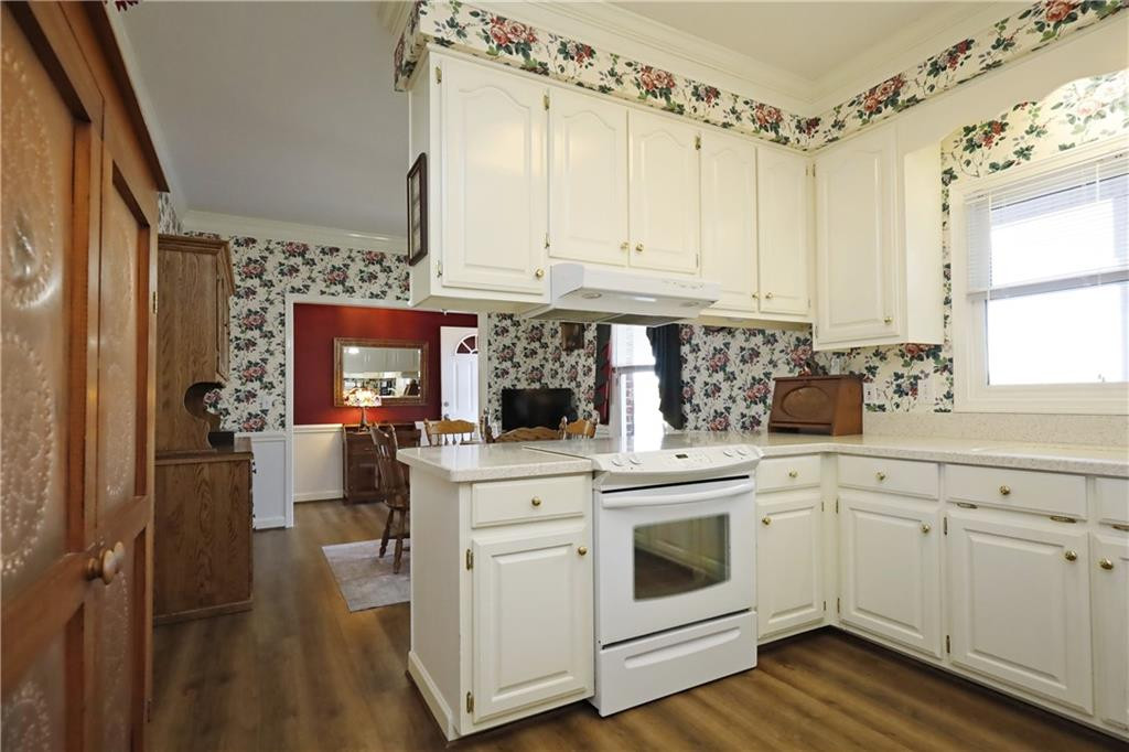 1670 Deep Creek Church Road Burlington, NC 27217 - Photo 15 of 36 a kitchen with white cabinets and white appliances