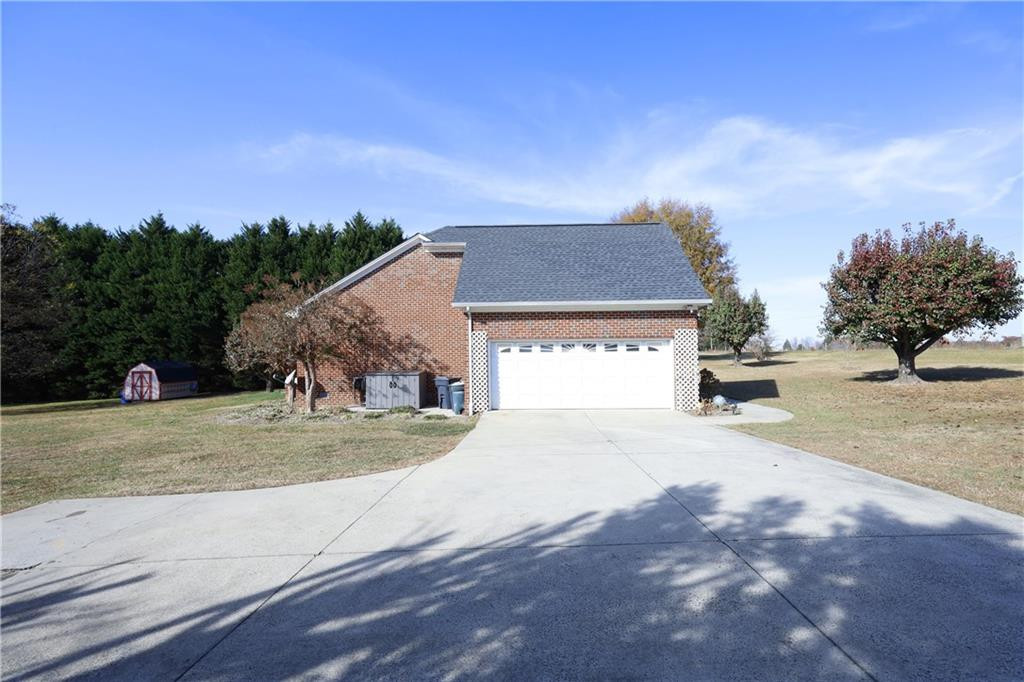 1670 Deep Creek Church Road Burlington, NC 27217 - Photo 2 of 36 a front view of a house with a yard and garage