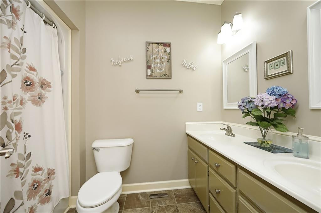 1670 Deep Creek Church Road Burlington, NC 27217 - Photo 21 of 36 a bathroom with a toilet sink and mirror