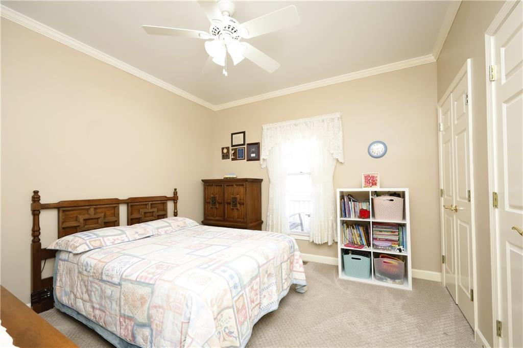 1670 Deep Creek Church Road Burlington, NC 27217 - Photo 25 of 36 a bedroom with a bed and a chandelier