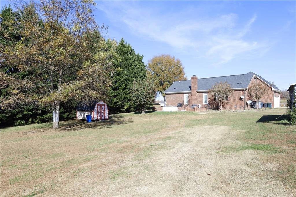 1670 Deep Creek Church Road Burlington, NC 27217 - Photo 29 of 36 a view of a house with a yard