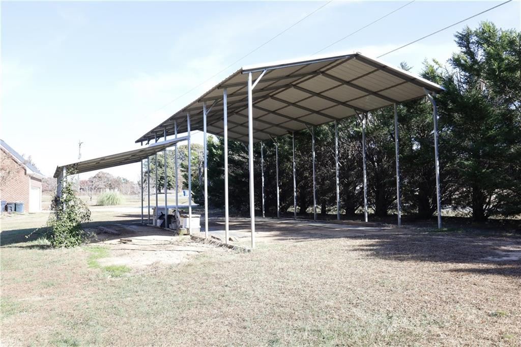 1670 Deep Creek Church Road Burlington, NC 27217 - Photo 35 of 36 a backyard of a house with barbeque oven table and chairs