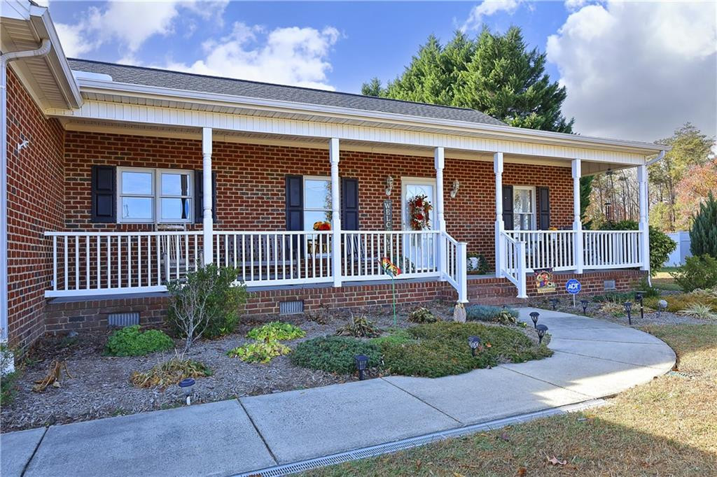 1670 Deep Creek Church Road Burlington, NC 27217 - Photo 4 of 36 a front view of a house with garden