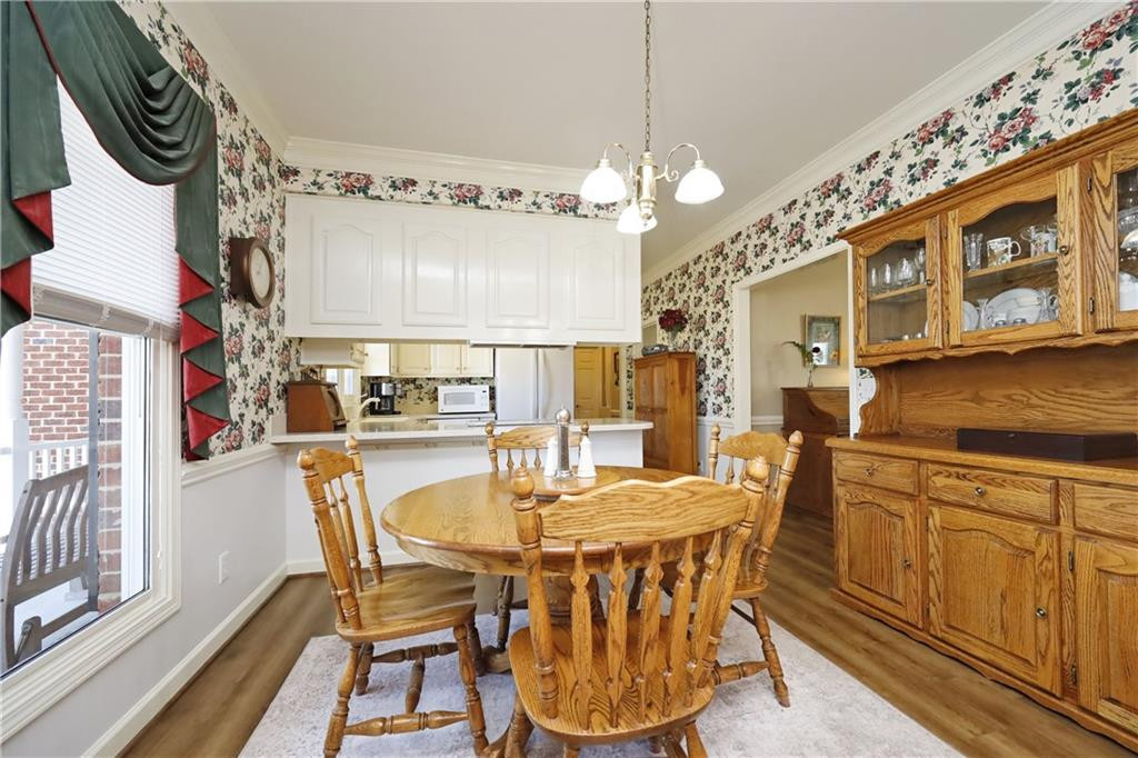 1670 Deep Creek Church Road Burlington, NC 27217 - Photo 8 of 36 a view of a dining room with furniture a chandelier and wooden floor
