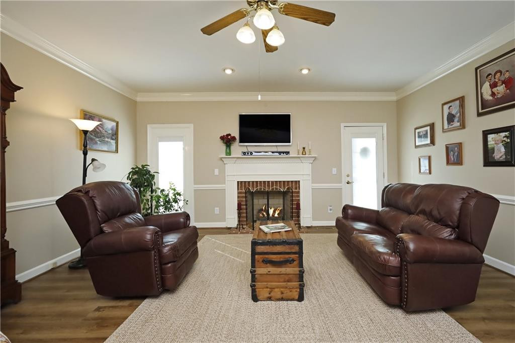 1670 Deep Creek Church Road Burlington, NC 27217 - Photo 9 of 36 a living room with furniture a flat screen tv and a fireplace