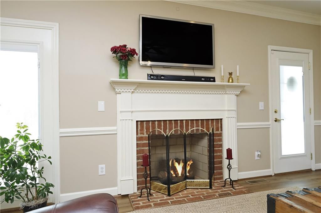 1670 Deep Creek Church Road Burlington, NC 27217 - Photo 10 of 36 a living room with a fireplace furniture and a flat screen tv