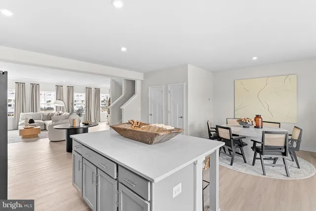 a kitchen with a stove a table and chairs