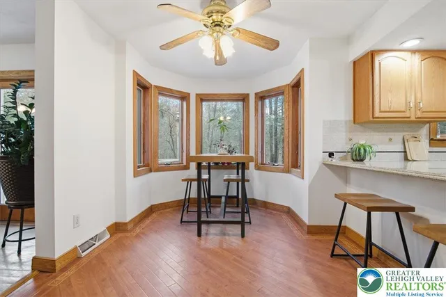 a spacious bathroom with a granite countertop sink and a mirror