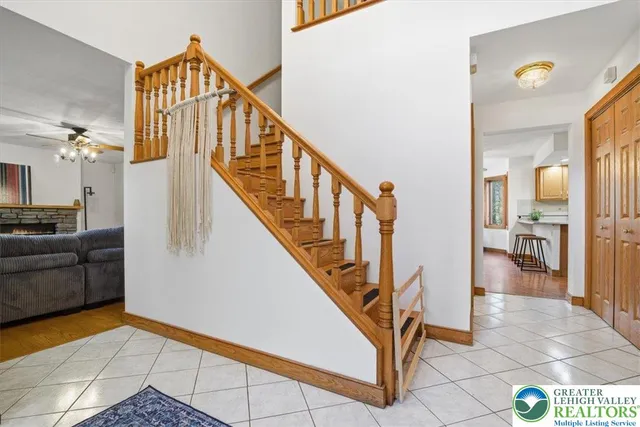 a kitchen with stainless steel appliances kitchen island granite countertop a refrigerator a stove top oven a sink dishwasher and white cabinets with wooden floor