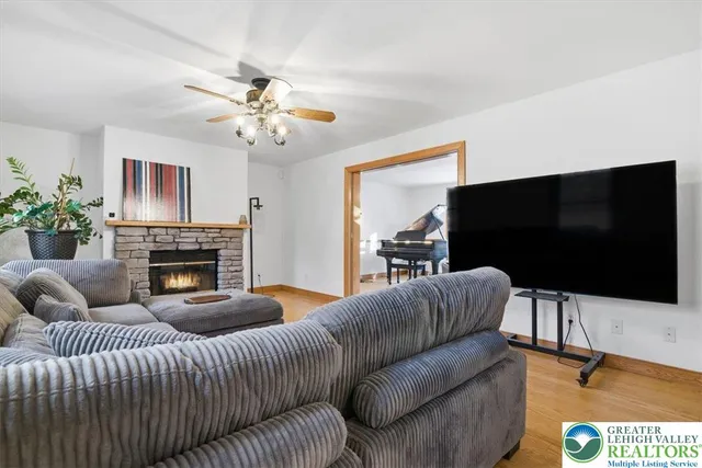 a kitchen with stainless steel appliances granite countertop wooden cabinets a sink a stove a dining table and chairs