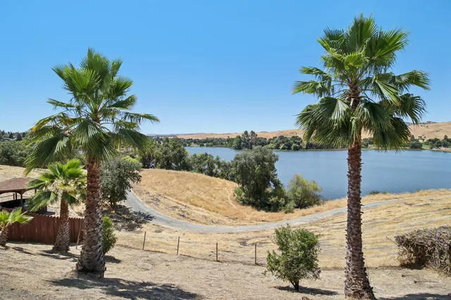 an aerial view of a house with swimming pool and mountain view