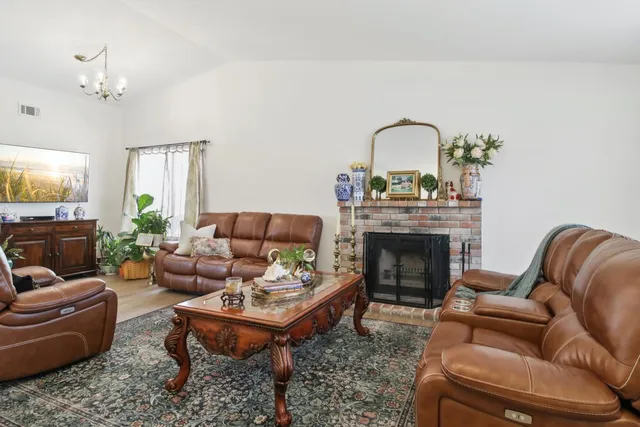 a living room with furniture a fireplace and a window