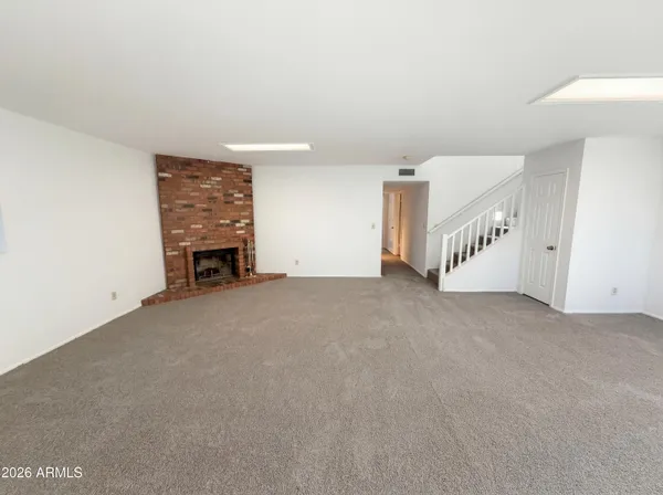 a view of an empty room with a fireplace