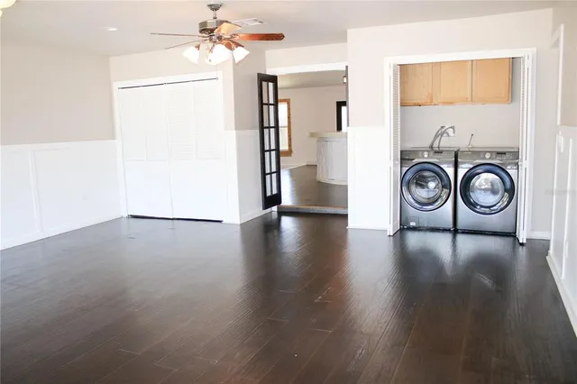 a view of empty room with wooden floor