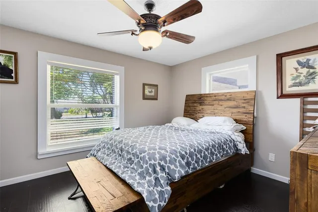 a bedroom with a bed dresser and a window