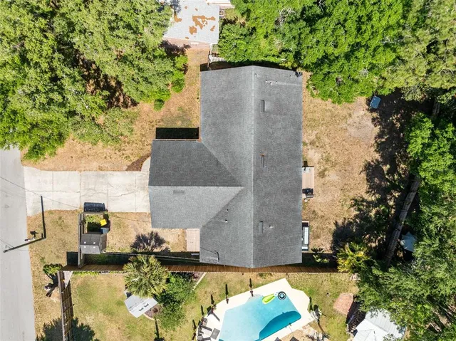 an aerial view of a house with a yard