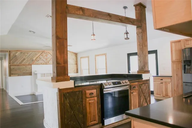 a kitchen with stainless steel appliances granite countertop a stove and a refrigerator