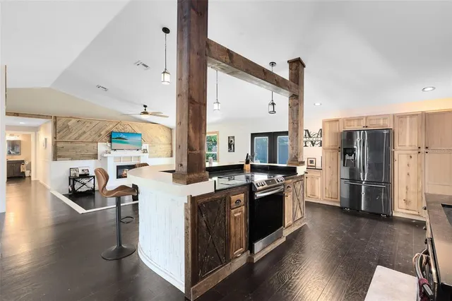 a kitchen with stainless steel appliances granite countertop a stove a refrigerator and a refrigerator