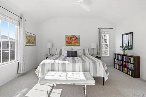 a bedroom with a bed couch and a fireplace