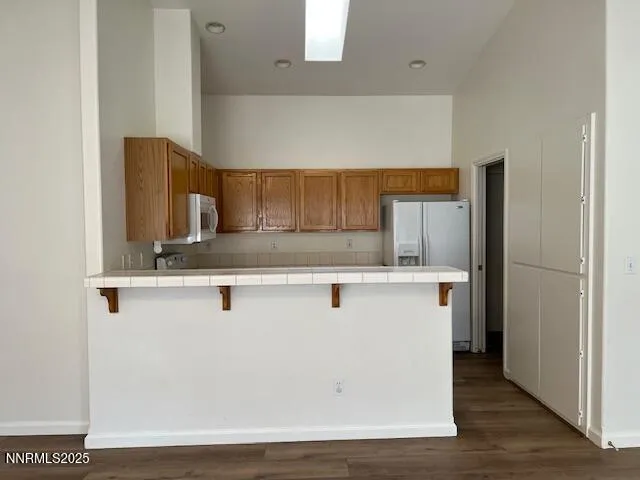 a view living room with granite countertop cabinets and wooden floor