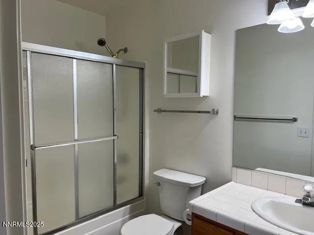 a white toilet sitting next to a bathroom sink