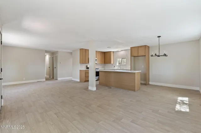a large kitchen with a sink and a stove top oven