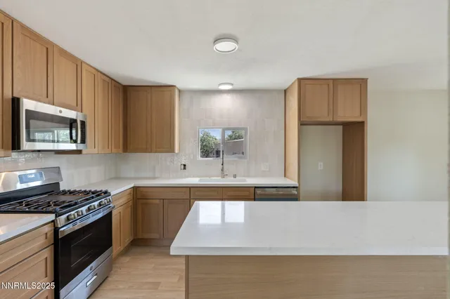 a kitchen that has a cabinets a sink and a stove in it