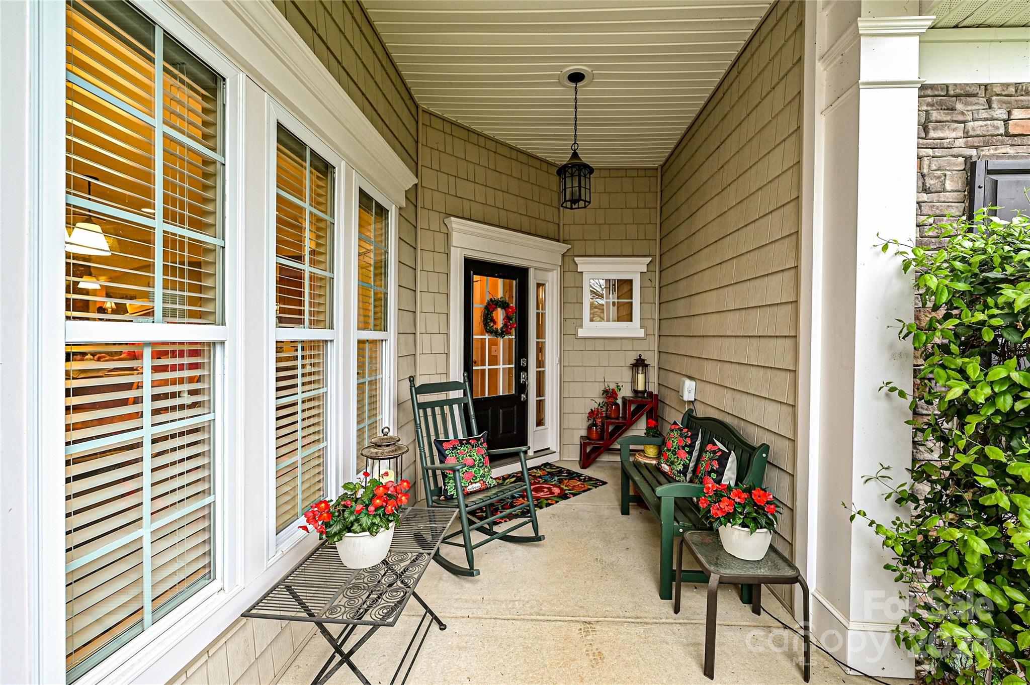a view of a porch with dining table and chairs and potted plants