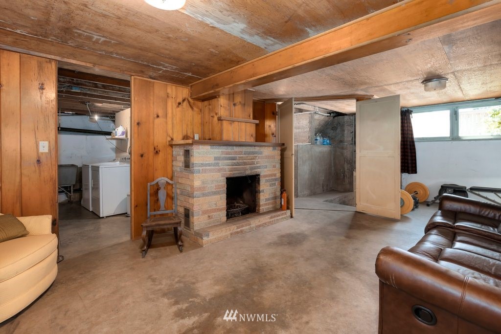 524 Southwest Sunset Boulevard Renton, WA 98057 - Photo 14 of 22 a living room with furniture and a fireplace