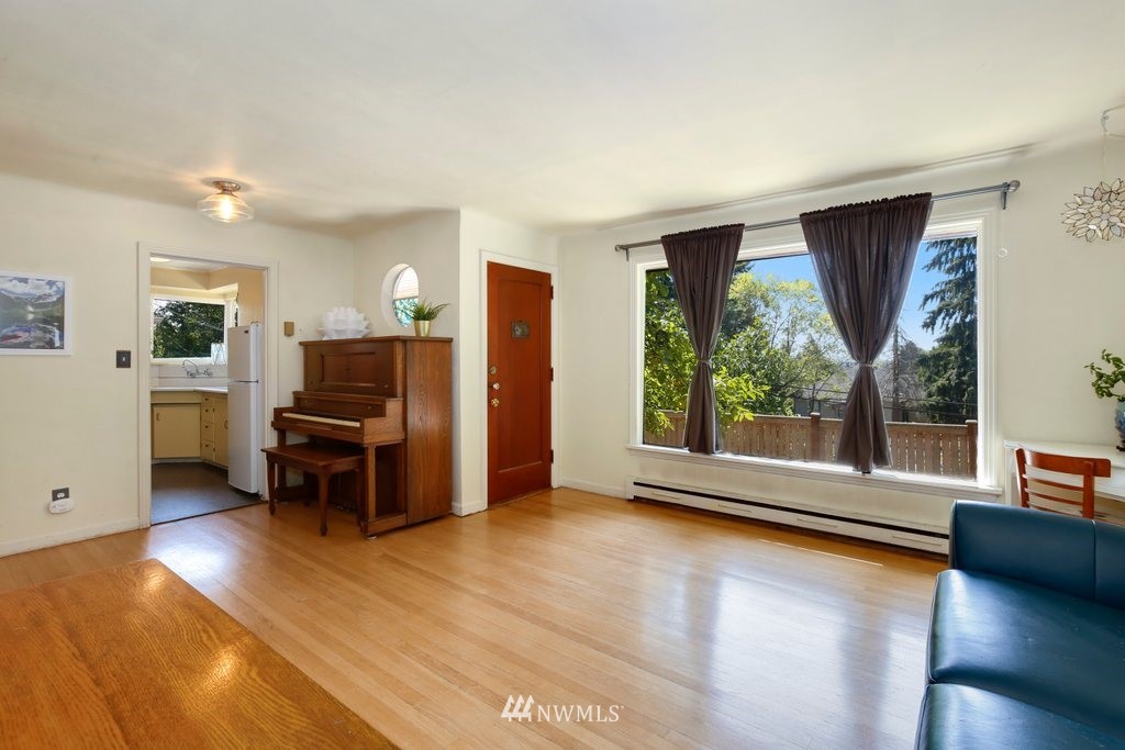 524 Southwest Sunset Boulevard Renton, WA 98057 - Photo 4 of 22 a view of room with window and wooden floor