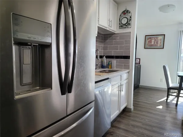 a kitchen with stainless steel appliances granite countertop a refrigerator and a stove