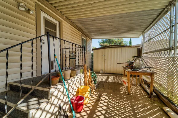 a balcony with chairs and table with wooden floor