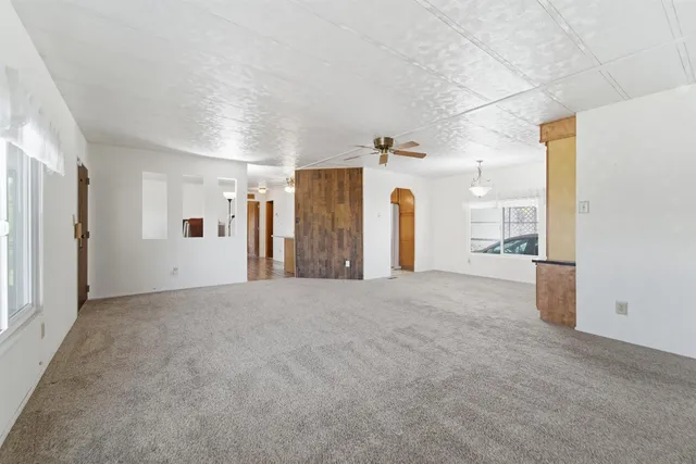 a view of a big room with closet and windows