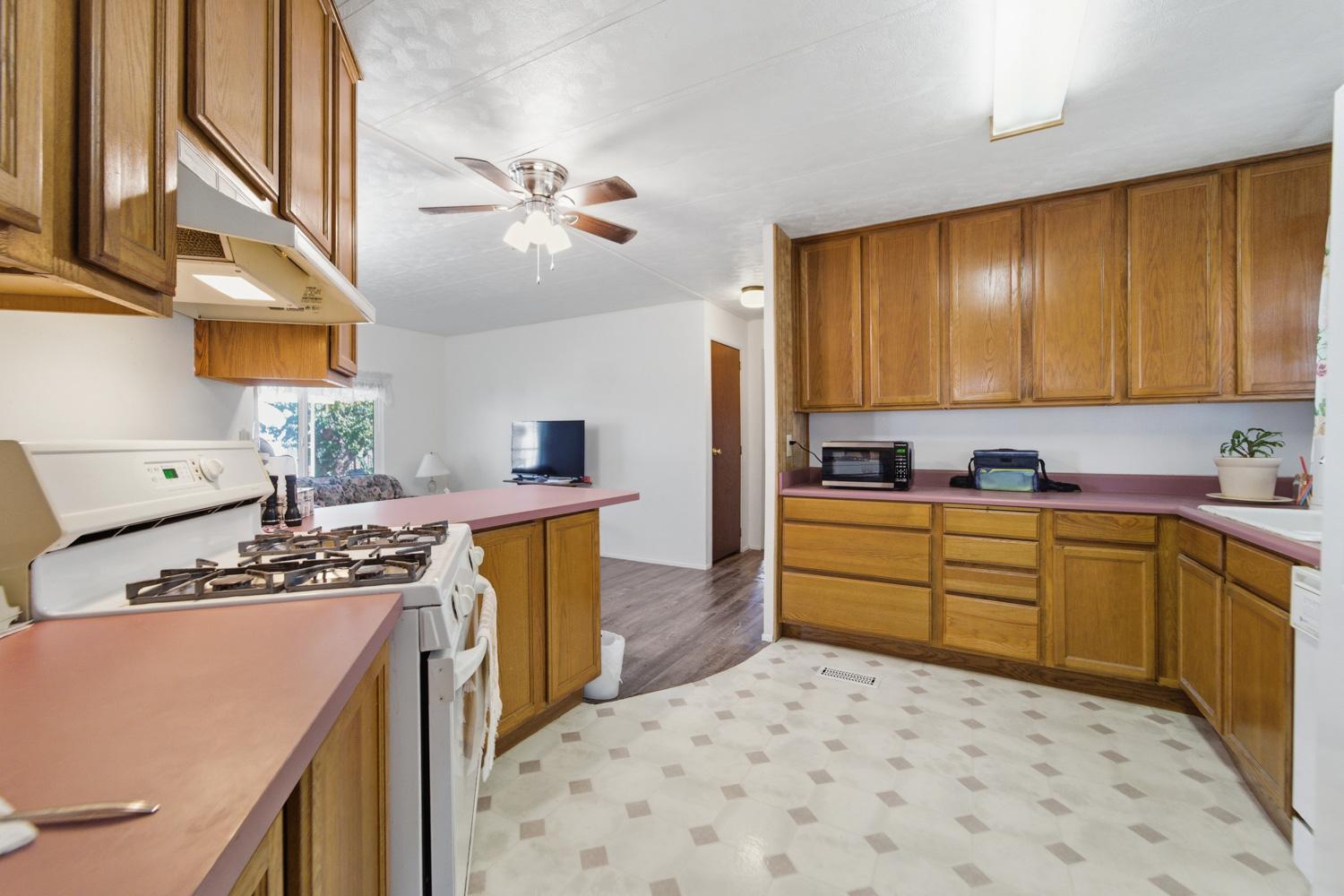 1155 Pease Road, Unit 514 Yuba City, CA 95991 - Photo 3 of 21 a kitchen with stainless steel appliances a stove a sink cabinets and a refrigerator