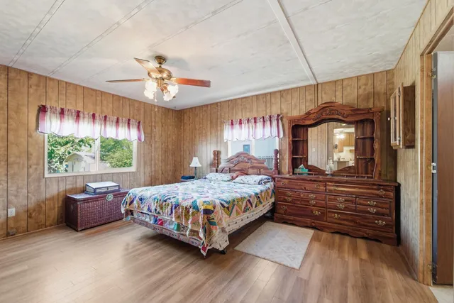 a room with a bed mirror and window