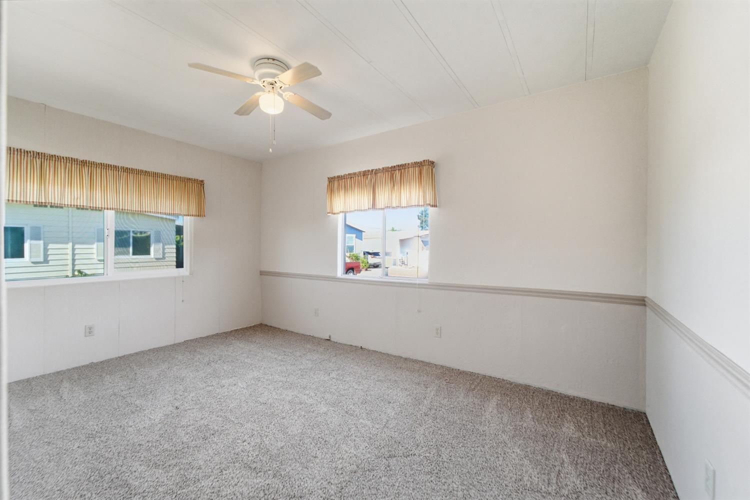 1155 Pease Road, Unit 514 Yuba City, CA 95991 - Photo 8 of 21 an empty room with windows and fan