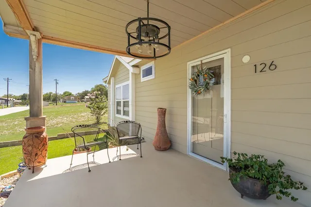 a spacious bedroom with a bed a couch and a large window