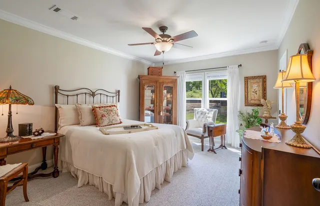 a view of a house with a yard and sitting area