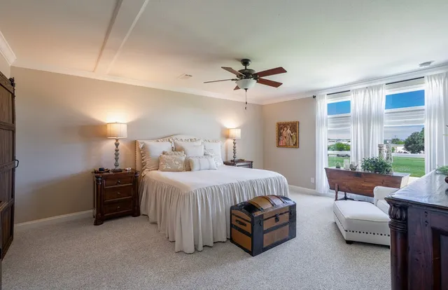 a kitchen with a sink a refrigerator and cabinets