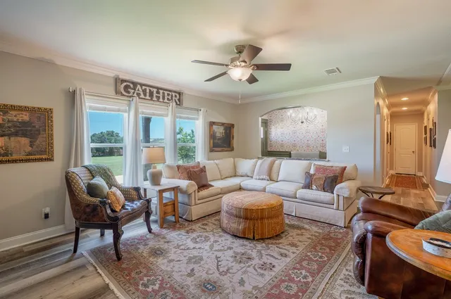 a kitchen with stainless steel appliances granite countertop a refrigerator a sink dishwasher a stove and a dining table with wooden floor