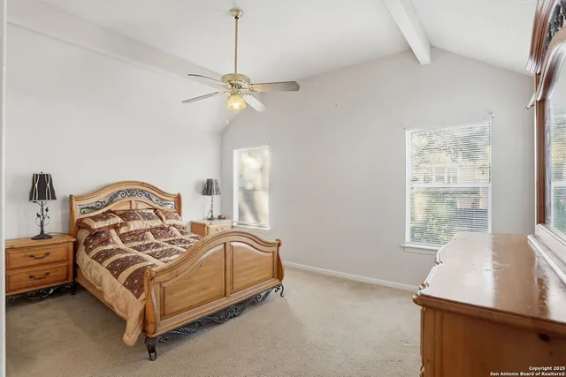 a spacious bedroom with a bed and window