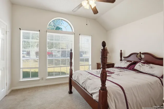 a bedroom with a bed and a large window