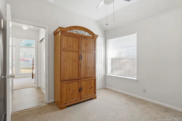 a view of a house with a yard and large tree