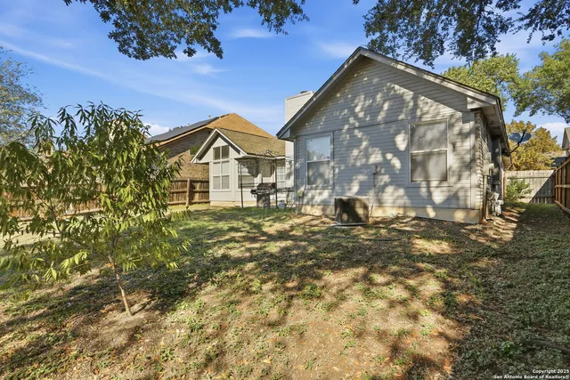 a view of a backyard with a tree