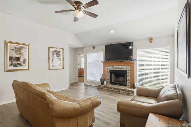 a living room with furniture a window and a fireplace