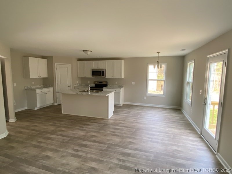 3034 Cricket Road Fayetteville, NC 28306 - Photo 4 of 11 a view of a kitchen with microwave and cabinets